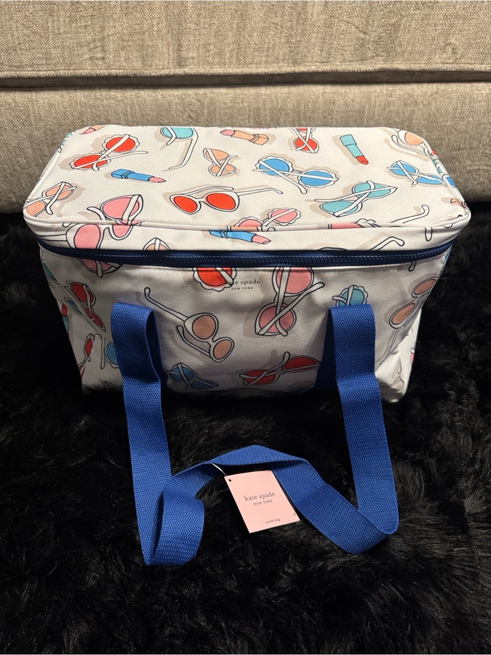 kate spade cream cooler  with colorful sunglasses and lipstick print